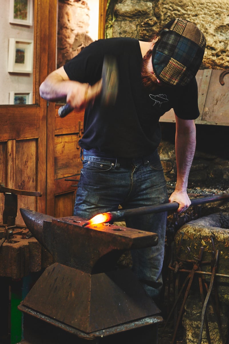 Traditional craftsperson working at a forge